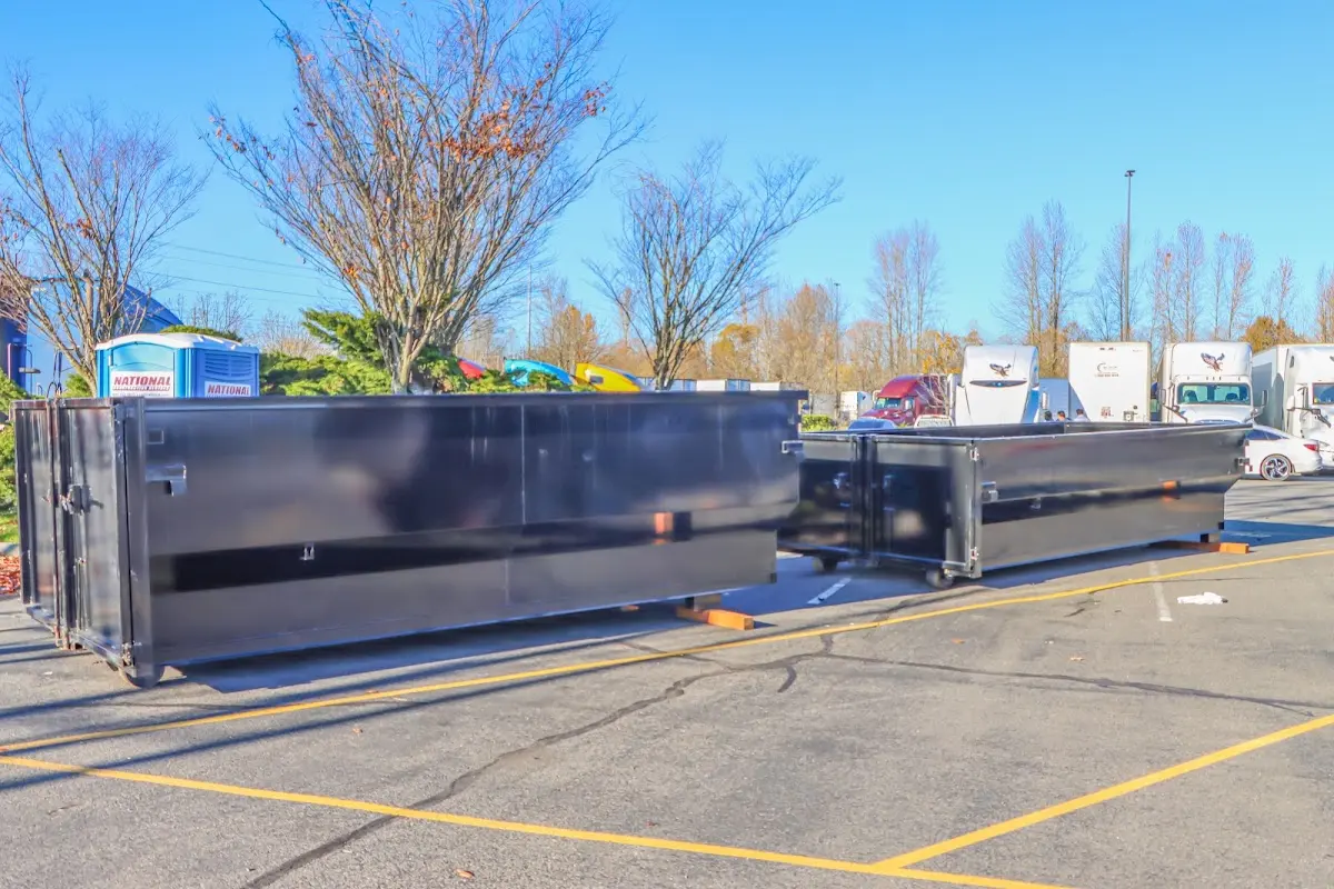 Professional dumpster rental service with roll-off container on residential driveway in Bull Mountain